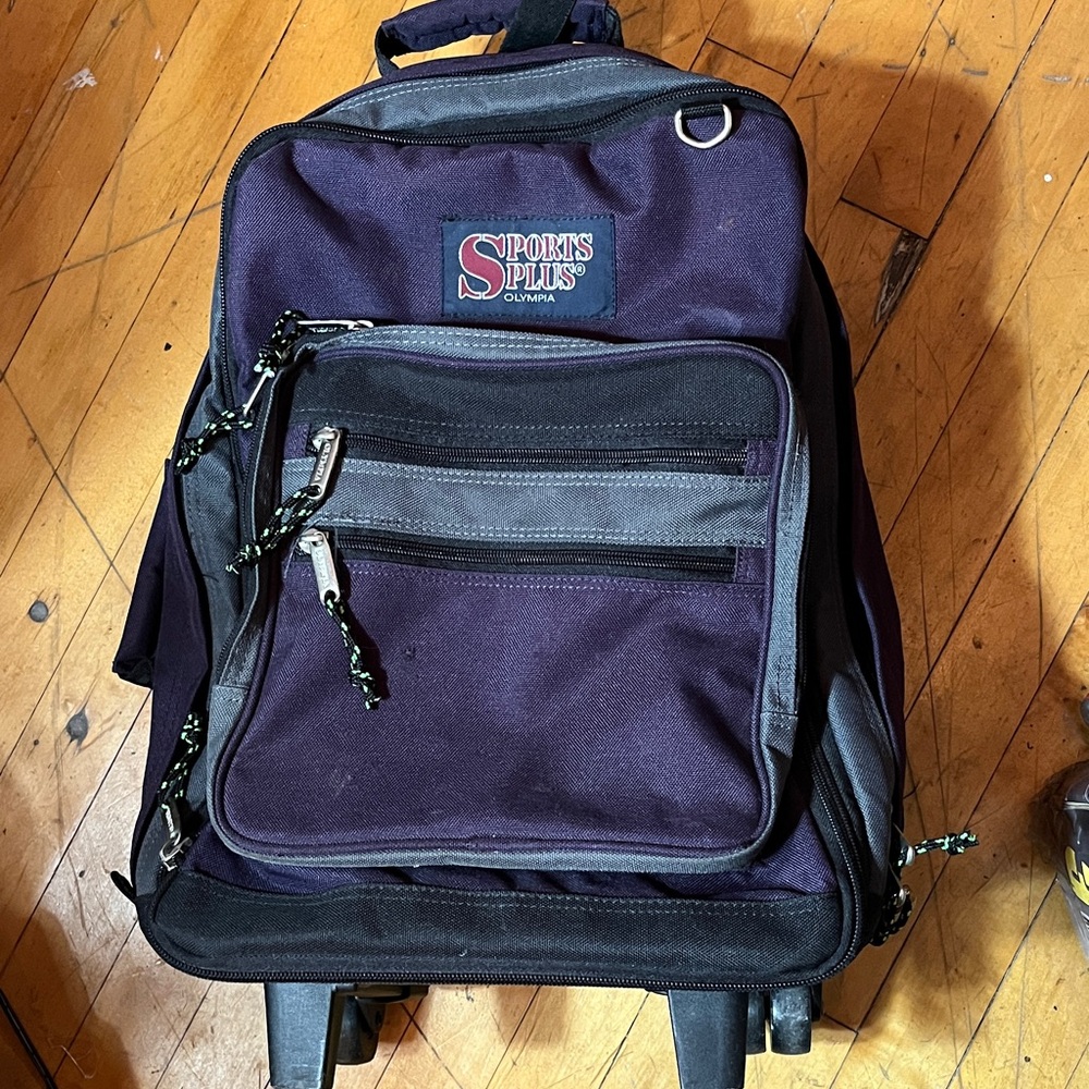 Olympia Sports Plus rolling backpack